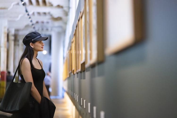 woman looking at art on the wall