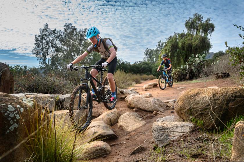 Two people mountain biking